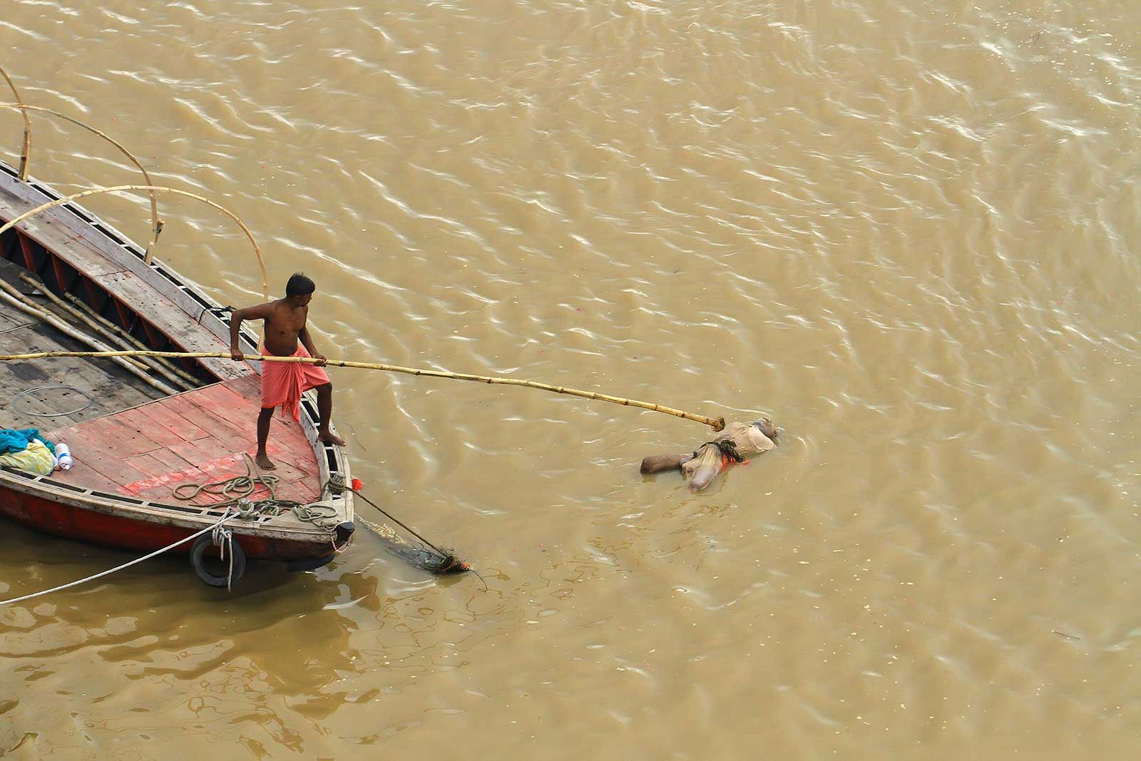 A dead body floating in the Ganges river in Varanasi, India.