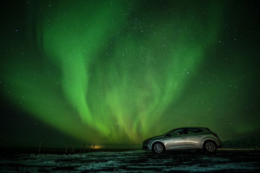 Car against the Northern Lights